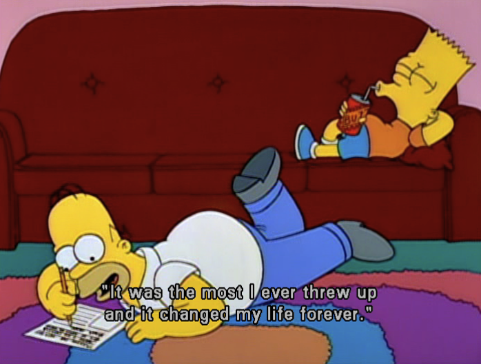 homer simpson finishing an essay with bart on the couch