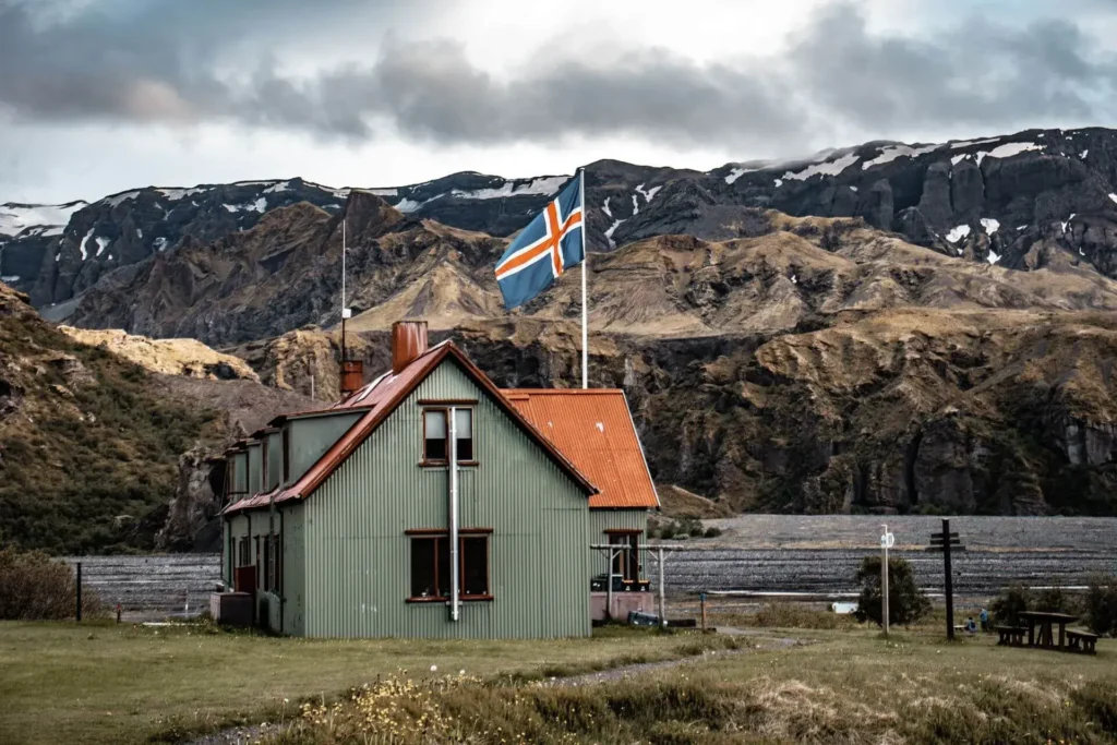 The flag of Iceland flying over an Icelandic landscape