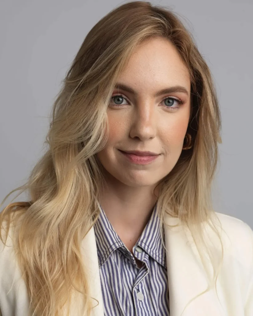 An example of a corporate headshot showing a blond woman in a cream-colored blazer
