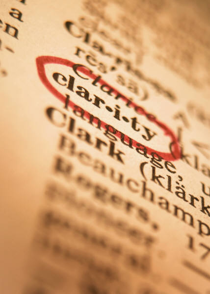 Photo of a close-up shot of a dictionary page, at an angle.  The word "clar-i-ty" is circled in red ink.